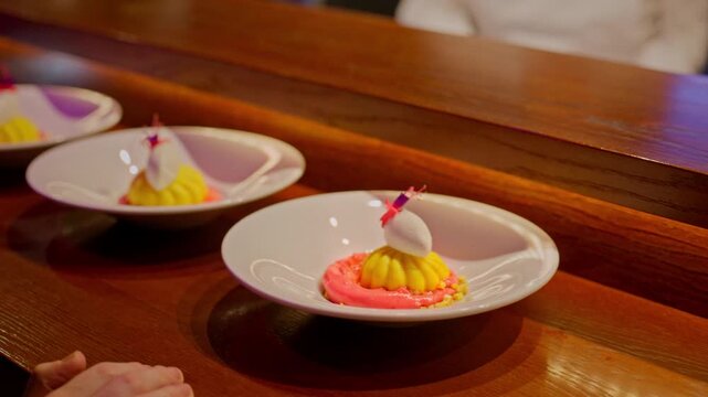 A gourmet dinner at a restaurant. Gastronomic food and dishes. Decorations and sophistication of signature dishes from the chef. Food as art. Bright colors of the dishes.