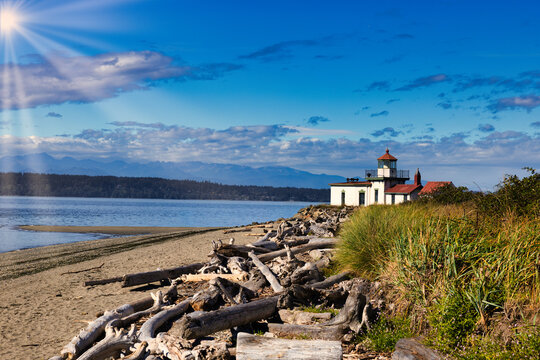 Discovery Park's West Point Lighthouse, sunny beach, mountains.