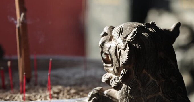 Close-ups and shallow depth-of-field shots capture the moment when incense is burning, and smoke swirls in the temple, showcasing a solemn and tranquil cultural image.