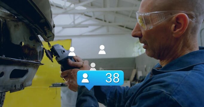 Mechanic using angle grinder smoothing panel at body shop and updating count bubble to ninety five