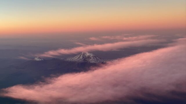 Aerial view of Mt. Ararat and Little Mount Ararat at sunset with colorful clouds and snowy peaks. Turkish name Ağrı Dağı