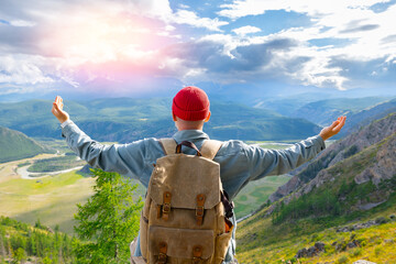 Happy hipster tourist with backpack embracing stunning Altai mountains landscape, Russia