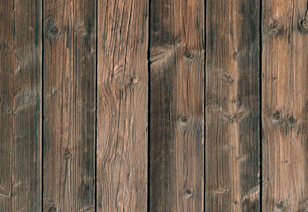 Fototapeta premium Wooden planks arranged in a vertical pattern show natural grain and textures in a simple wooden surface