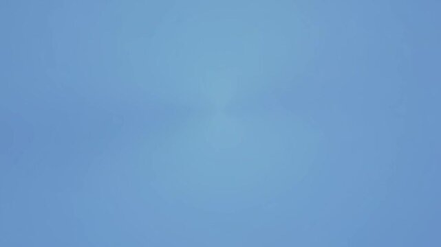 A peaceful gradient of soft blue hues converging towards the center point