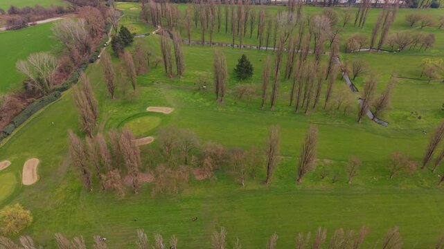 Golf Course Oasis: An aerial view showcases the serene beauty of a golf course, the vibrant green fairways and meticulously maintained greens offering a picturesque setting for leisure and sport. 