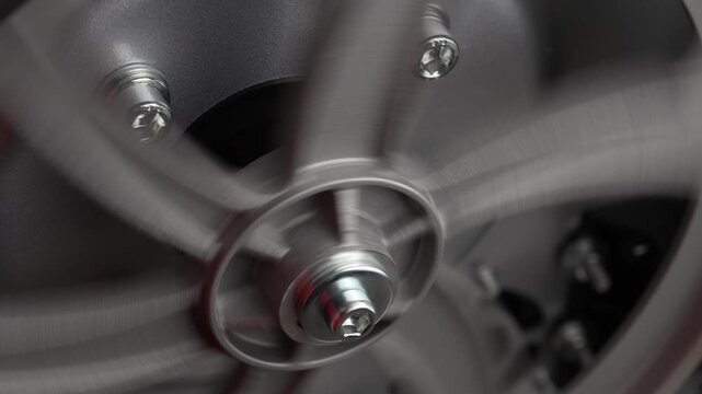 Metal wheel mechanism on a shaft of an industrial machine, rotation, close up