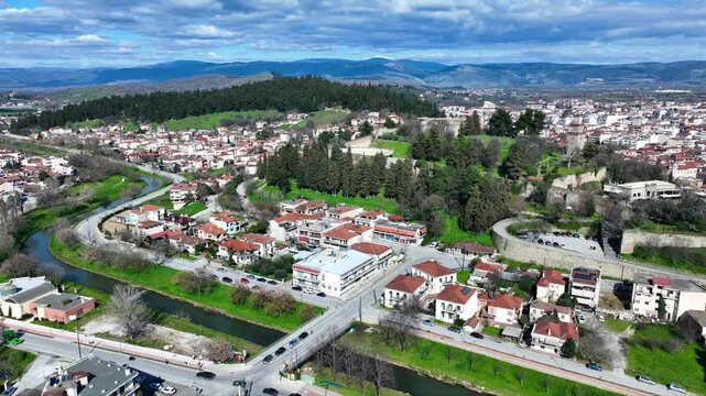 Aerial drone cinematic rotational video of iconic Byzantine castle of Trikala ancient citadel built northeastern side of the city in a small hill featuring clock tower with great views in old city of 