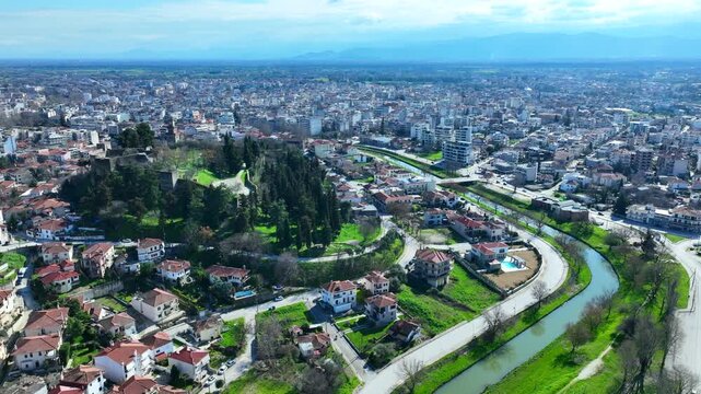 Aerial drone cinematic rotational video of iconic Byzantine castle of Trikala ancient citadel built northeastern side of the city in a small hill featuring clock tower with great views in old city of 