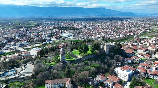 Aerial drone cinematic rotational video of iconic Byzantine castle of Trikala ancient citadel built northeastern side of the city in a small hill featuring clock tower with great views in old city of 
