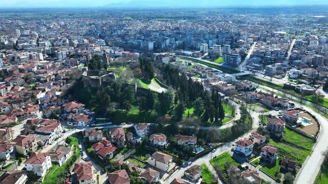 Aerial drone cinematic rotational video of iconic Byzantine castle of Trikala ancient citadel built northeastern side of the city in a small hill featuring clock tower with great views in old city of 