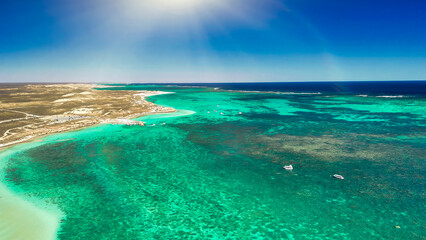 Obraz premium Aerial view of Coral Bay and beach in Western Australia with turquoise ocean and white sand