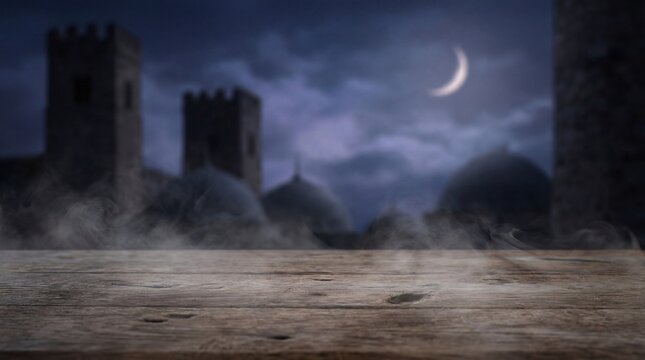 Empty wooden tabletop with a mysterious medieval castle background at night.