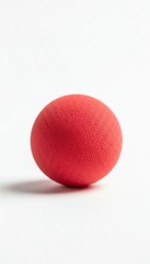 Red rubber ball on white background for April Fool&rsquo;s Day  