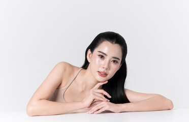 Naklejka premium Beautiful asian woman smiling showing care teeth and glowing face skin makeup, for advertise skincare product, self care and cosmetics concept.