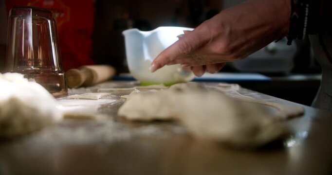 Shaping and folding traditional Polish dumplings (polskie pierogi) with cheese and potato filling | 4K Video
