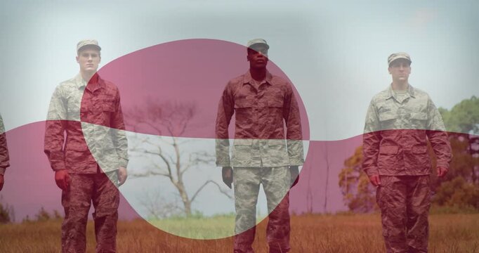 Military troops in camo walking from left, stopping into line while pink band sweeping over torsos