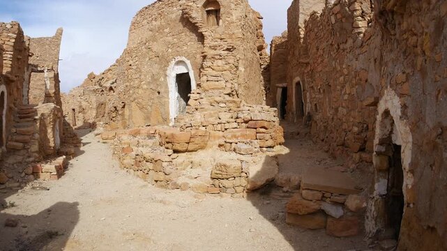 Panorama: Ancient Ksar Guermassa in southern Tunisia, featuring traditional Berber mudbrick granaries and arched storage rooms, showcasing Saharan architecture, history, and cultural heritage