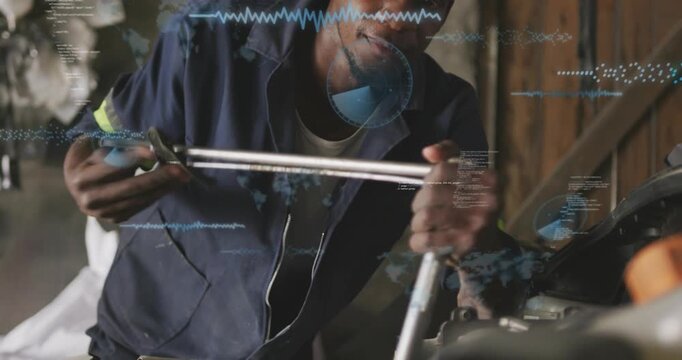 Tech grasping wrench applying torque on engine while blue HUD guiding repair and assistant holding