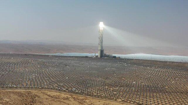 Aerial view of Ashalim solar power station tower and heliostats in the Negev desert wilderness Israel