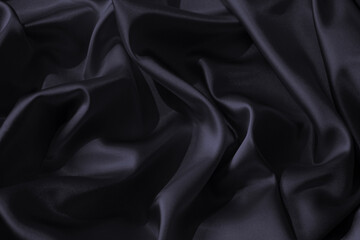 Fototapeta premium Black dark blue graphite silk shiny fabric material. Elegant luxury subtle style background. Wavy curve line soft folds drapery . Smoky muted dusty shade color. Empty. Design.