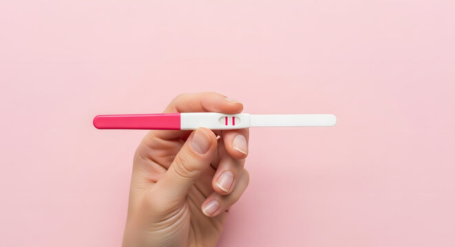 Hand Holding Positive Pregnancy Test with Two Red Lines on Pink Background. Generative AI