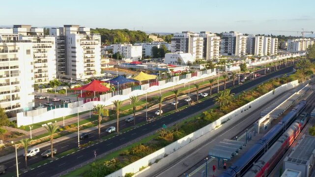 High angle aerial view of Nahariya city, Israel, featuring the train station, modern residential buildings, and urban landscape at sunset