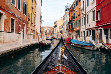 Obraz premium Gondola ride through canals in Venice with buildings lining the waterway