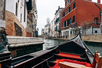 Gondola ride through the canals of Venice during a cloudy day in Italy © fotofabrika