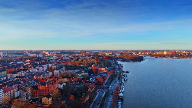 Footage over the riverfront with beautiful historical buildings. Sunset in beautiful Stockholm, Sweden.