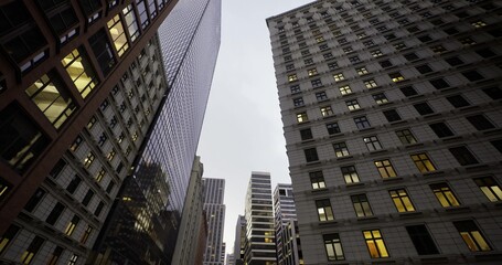 Fototapeta premium Nighttime buildings with glowing windows, Tall structures create canyon under night sky, Skyscrapers illuminate city canyon with vibrant office lights today