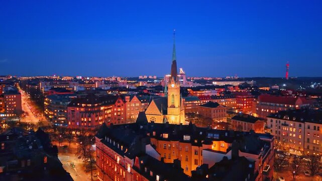 Panorama of old Stockholm, Sweden with gorgeous illumination at night. View on Neo-Gothic Oscar's Church in the center. Aerial perspective.