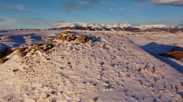 Rock formations and distant mountains under moon 