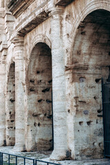 Naklejka premium Columns of ancient structure in urban setting with clear blue sky in the background
