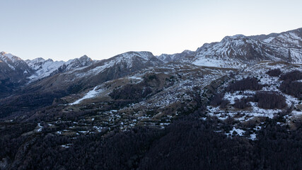 Aerial view of snowy mountain peaks and rocky slopes in the Pyrenees during winter twilight