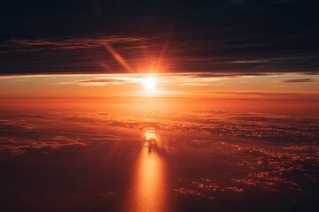 Stunning Aerial View of a Vibrant Orange Sunset Over a Cloud-Filled Horizon.