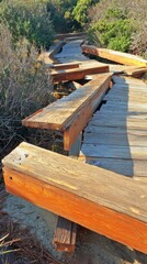 seismic. Wooden boardwalk fractured and displaced by seismic activity. ESG reports, sustainability campaigns, designed for sustainability communications and ESG reporting, drives climate awareness.
