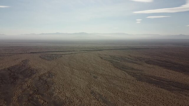 Long train traveling through huge desert 