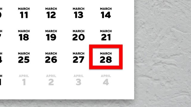 The date March 28th marked with a red cursor on the wall calendar 2026