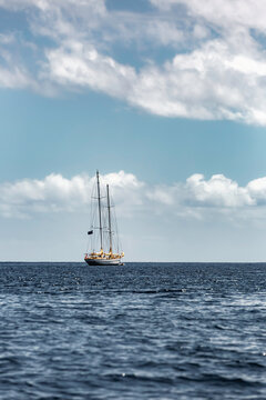 Faial, Azores, Island, Sailboat is floating in the ocean with a clear blue sky in the background