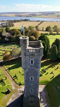 Cinematic Aerial Drone View of Macdonald Memorial Tower Overlooking Dingwall Town in the Scottish Highlands, Scotland &ndash; Historic Landmark Architecture Surrounded by Scenic Landscape and Highland Atmos