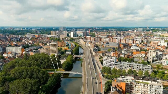 Ghent, Belgium. Esco (Scheldt) river embankment. Panorama of the city from the air. Cloudy weather, summer day. Drone footage