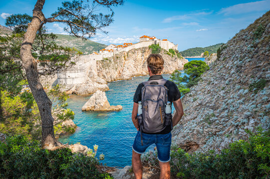 Backpacker Seen from Behind Standing on a Rock at the Viewpoint of Old Fortress in Dubrovnik, Croatia