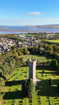 Cinematic Aerial Drone View of Macdonald Memorial Tower Overlooking Dingwall Town in the Scottish Highlands, Scotland &ndash; Historic Landmark Architecture Surrounded by Scenic Landscape and Highland Atmos
