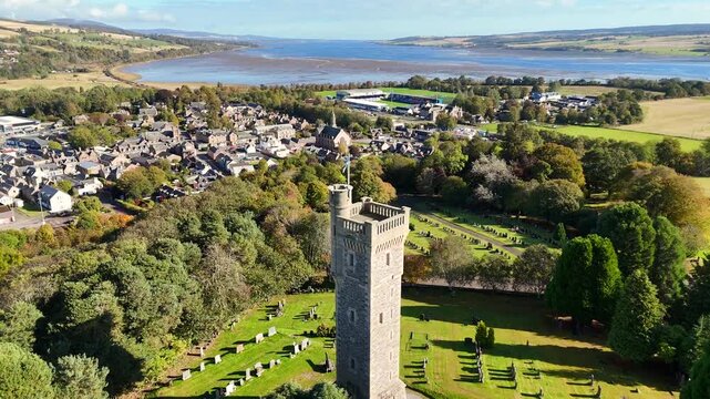 Epic Cinematic Drone Flight Above Macdonald Memorial Tower and Dingwall Town in the Scottish Highlands, Scotland &ndash; Historic Stone Landmark Rising Over Scenic Highland Landscape
