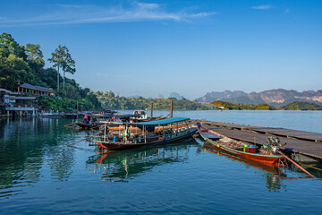 Fototapeta premium Traditional long-tail boats on wharf in Cheow Lan Lake, Khao Sok National Park, Surat Thani Province, Thailand.