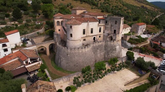 Castello Pandone Venafro aerial 4k close up and pull back view in Italy. Cinematic drone flight from medieval castle to wide city panorama in Molise. Historic fortress and heritage scenery. hidden gem
