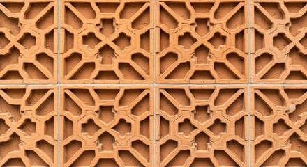 Naklejka premium Terracotta breeze block wall pattern with ornate clover and cross shaped cutouts for ventilation and architectural decoration in modern mediterranean building designs and residential garden privacy