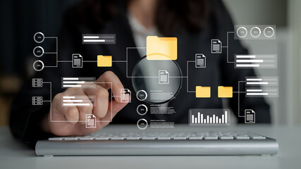 A business professional uses a magnifying glass to analyze digital data and organize files,...