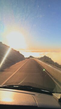 Cinematic mountain road descent with sea of clouds at sunset, Madeira island