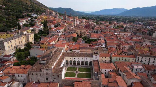 Venafro aerial 4k view of city with red roofs and churches in Italy. Cinematic drone panorama of historic town in Molise surrounded by mountains. Authentic Italian architecture and cityscape scenery